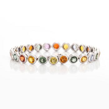 An 18K white gold bracelet, set with multicoloured sapphires.