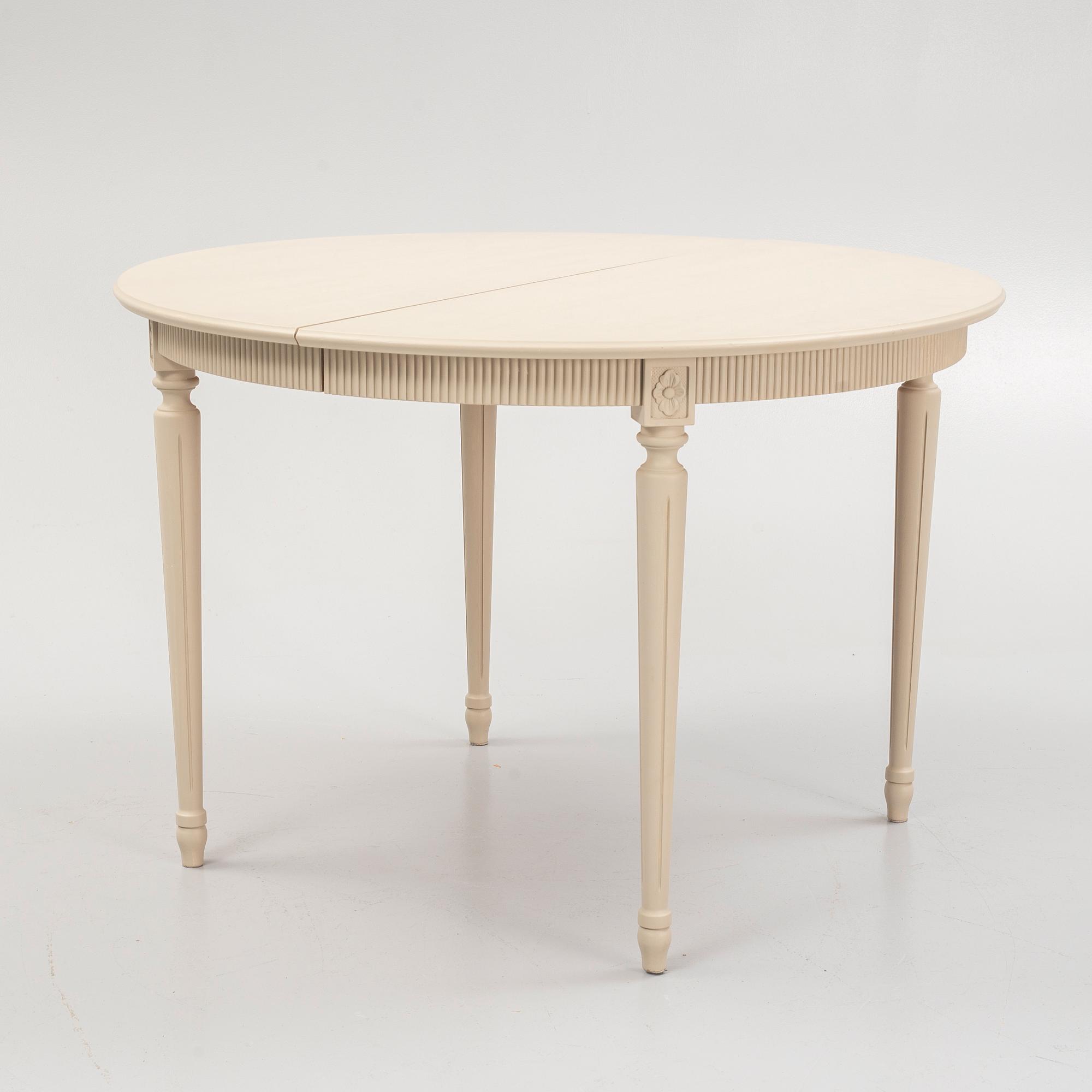 A Gustavian style dining table and eight chairs, late 20th Century.