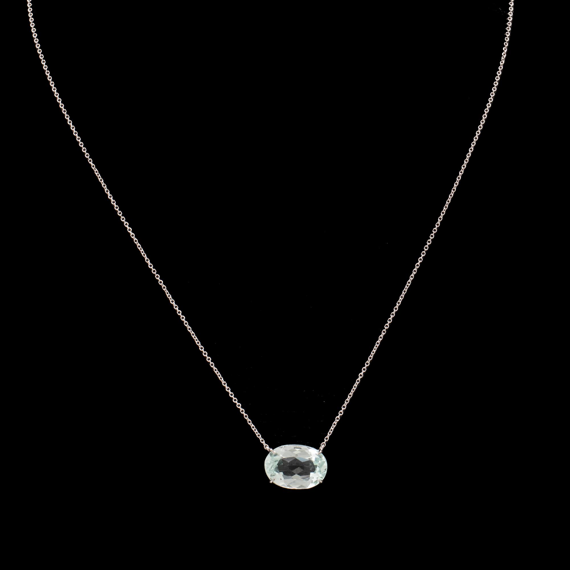 An 18K white gold necklace with an oval faceted aquamarine.