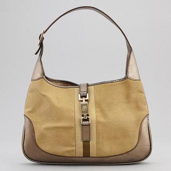 GUCCI, a metallic bag.