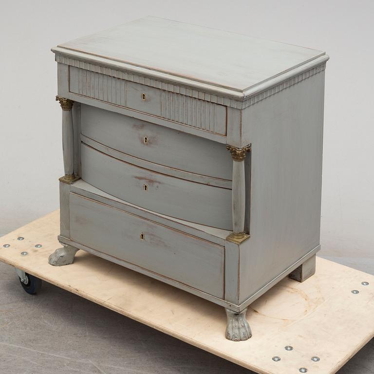 An empire style chest of drawers from around year 1900.