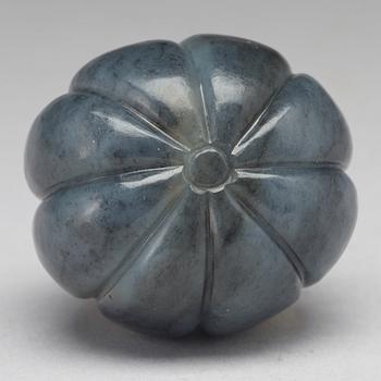 A Chinese nephrite sculpture of insects on a fruit.