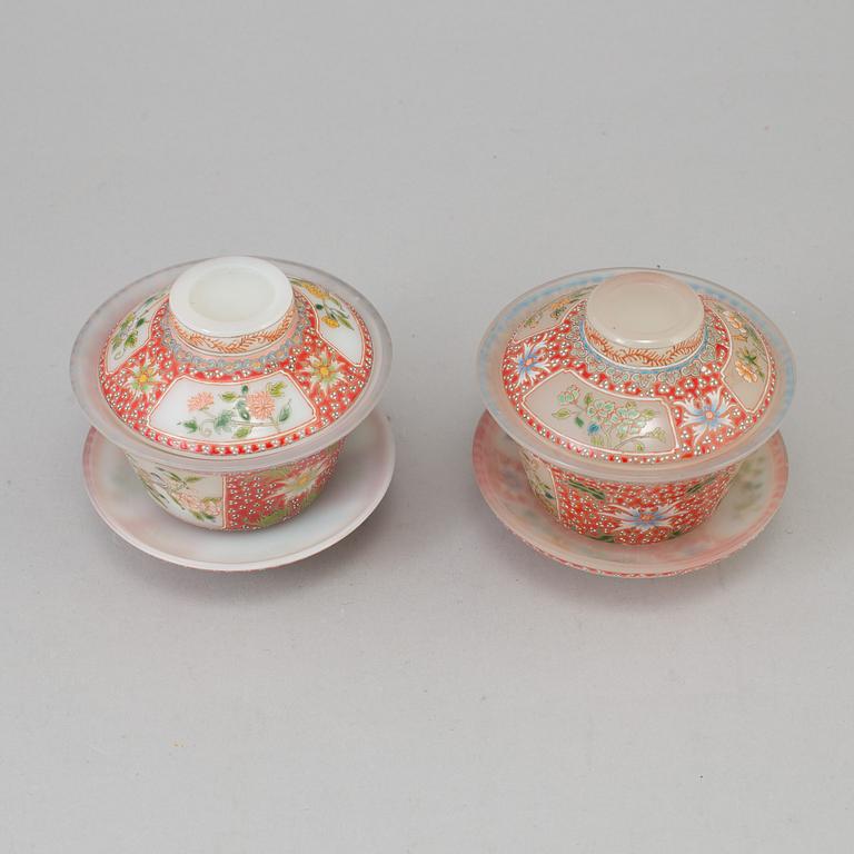 Two chinese peking glass wedding cups with cover and dishes, 20th century, with Qianlongs mark to the base.