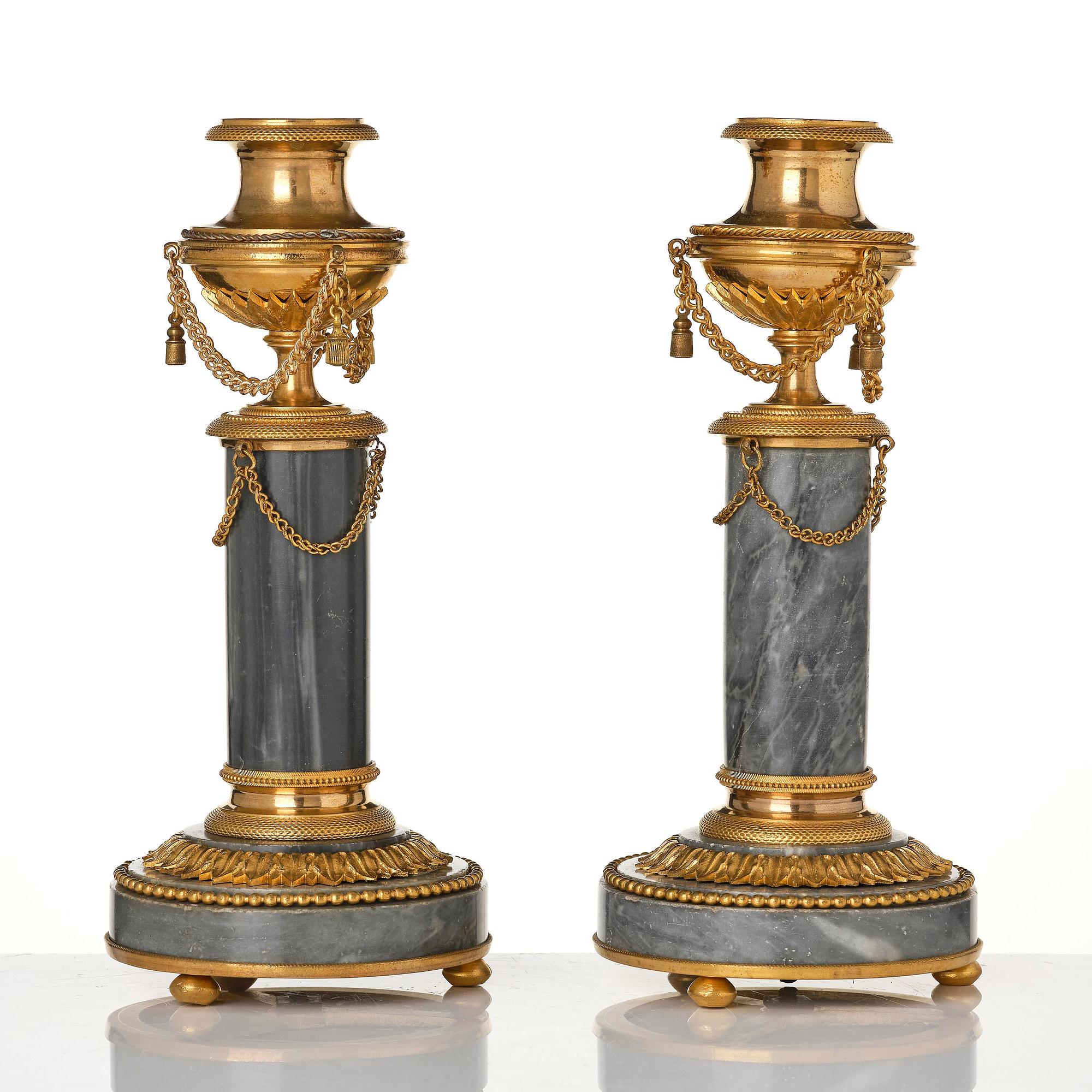 A pair of Louis XVI ormolu and Bleu turquin candlesticks.