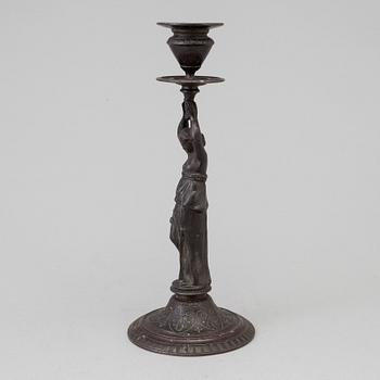 A 19th century iron candlestick marked F.L Vombach Offenbach A/M.