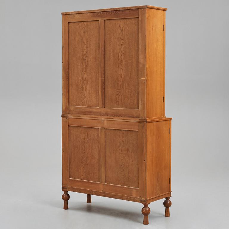 A Swedish Grace mahogany showcase cabinet, reportedly a win at the Stockholm Cabinetmaker's association lottery, 1920's.