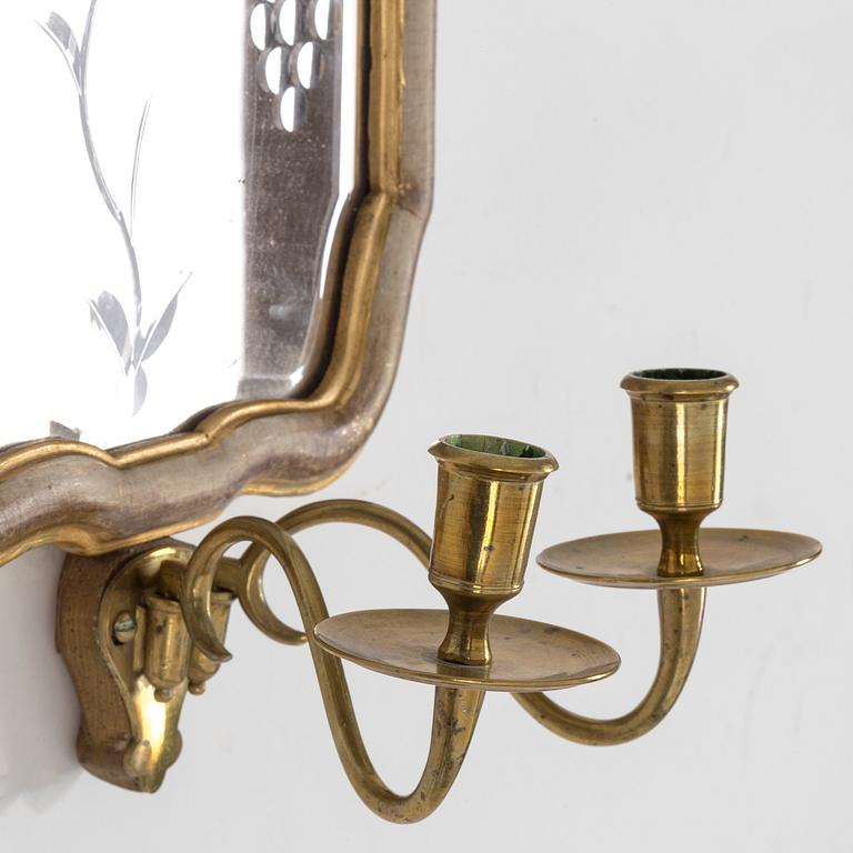 A pair of Swedish 18th century two-light girandole mirros.