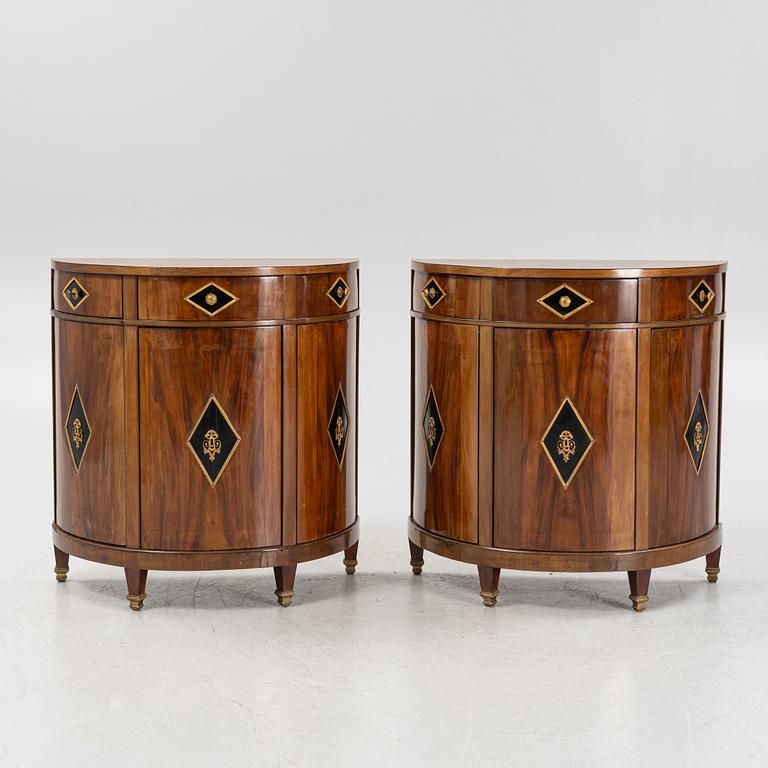 A pair of mahogany veneered empire style cabinets.