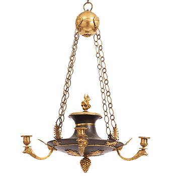 An ormolu and painted bronze four-light Empire chandelier, early 19th century.