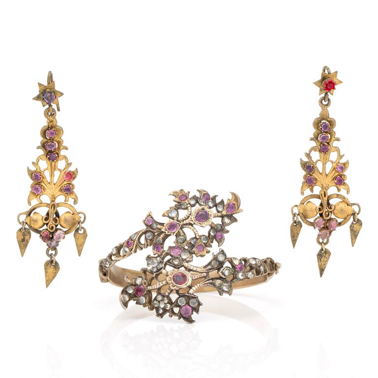 A silver gilt bracelet and earrings with faceted pink sapphires and rose-cut diamonds.