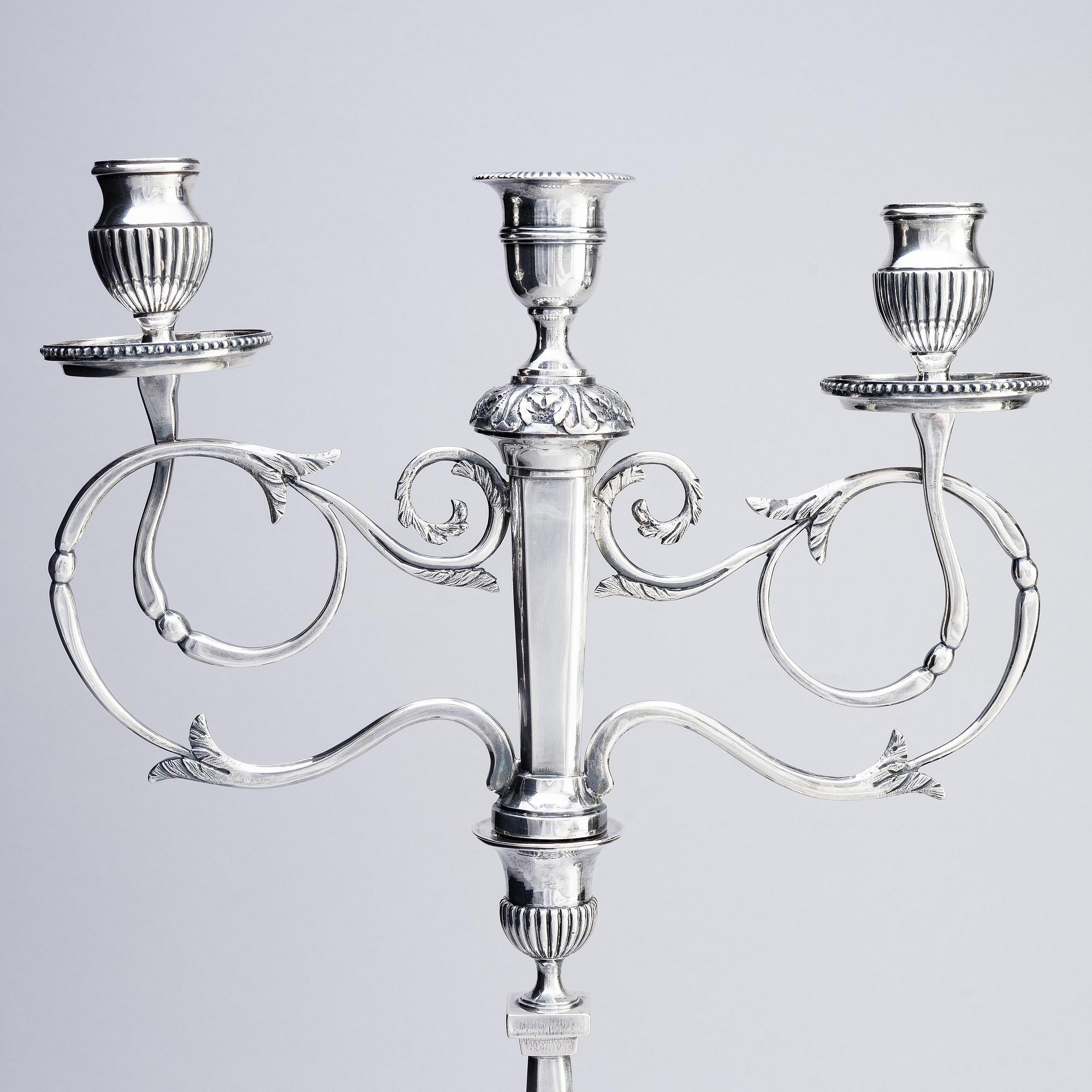 A pair of Swedish silver candelabras, marks of Pehr Zethelius, Stockholm 1797 and Daniel Hedberg, Eksjö 1829.