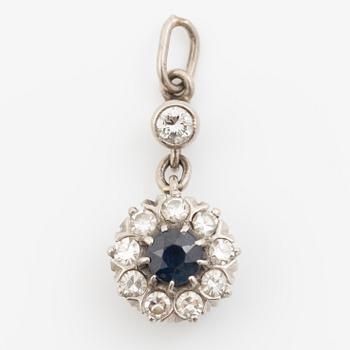 Pendant in 18K gold with a blue stone and diamonds.