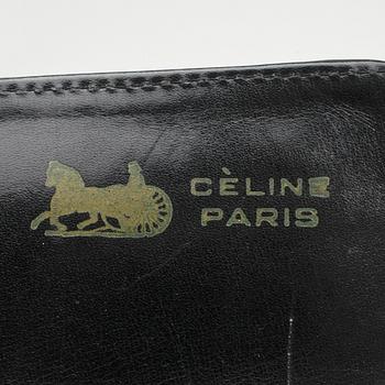 CÉLINE, a black leather shoulder bag and wallet.