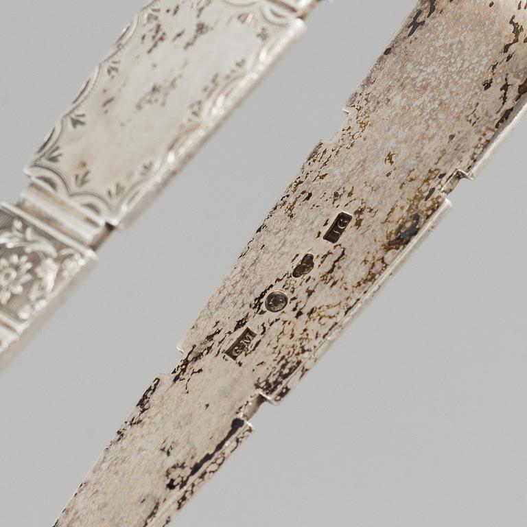 An English 18th century silver ladle, a silver tumbler and two silver sugar-tongs.