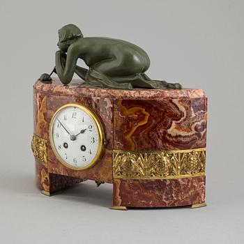 An early 20th century mantle clock with a bronze sculpture signed M. Charny.