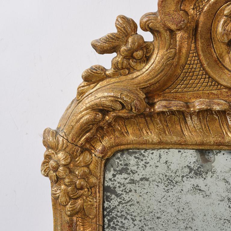 A two-branch giltwood rococo girandole mirror, Stockholm, later part 18th century.