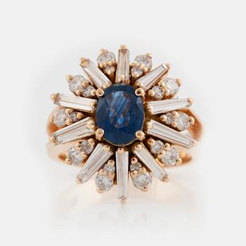 868. A RING set with a sapphire and brilliant- and trapezoid-cut diamonds.