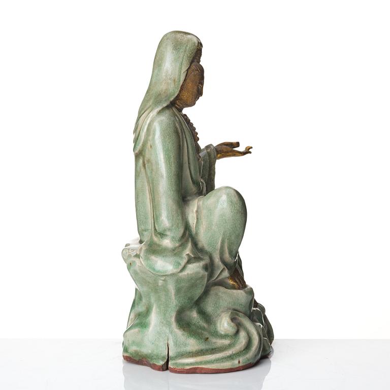 A seated celadon figure of Guanyin, presumably Longquan Ming dynasty, 17th Century.