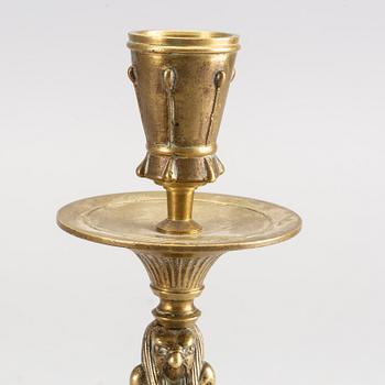 A pair of early 20th century brass candle sticks.