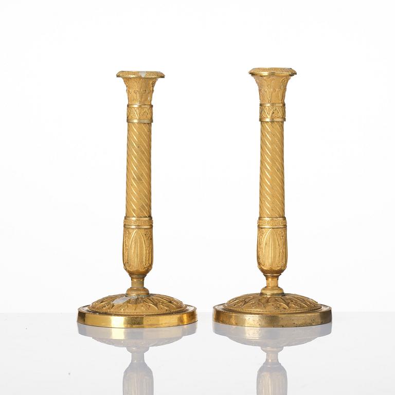 A pair of French Empire ormolu candlesticks, Paris, early 19th century.