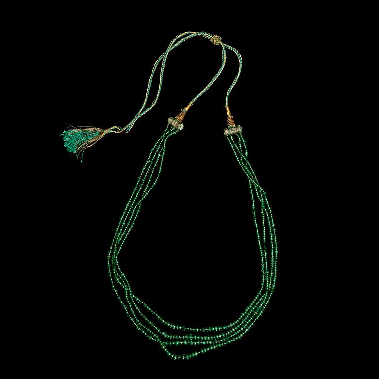 An emerald bead necklace. India.