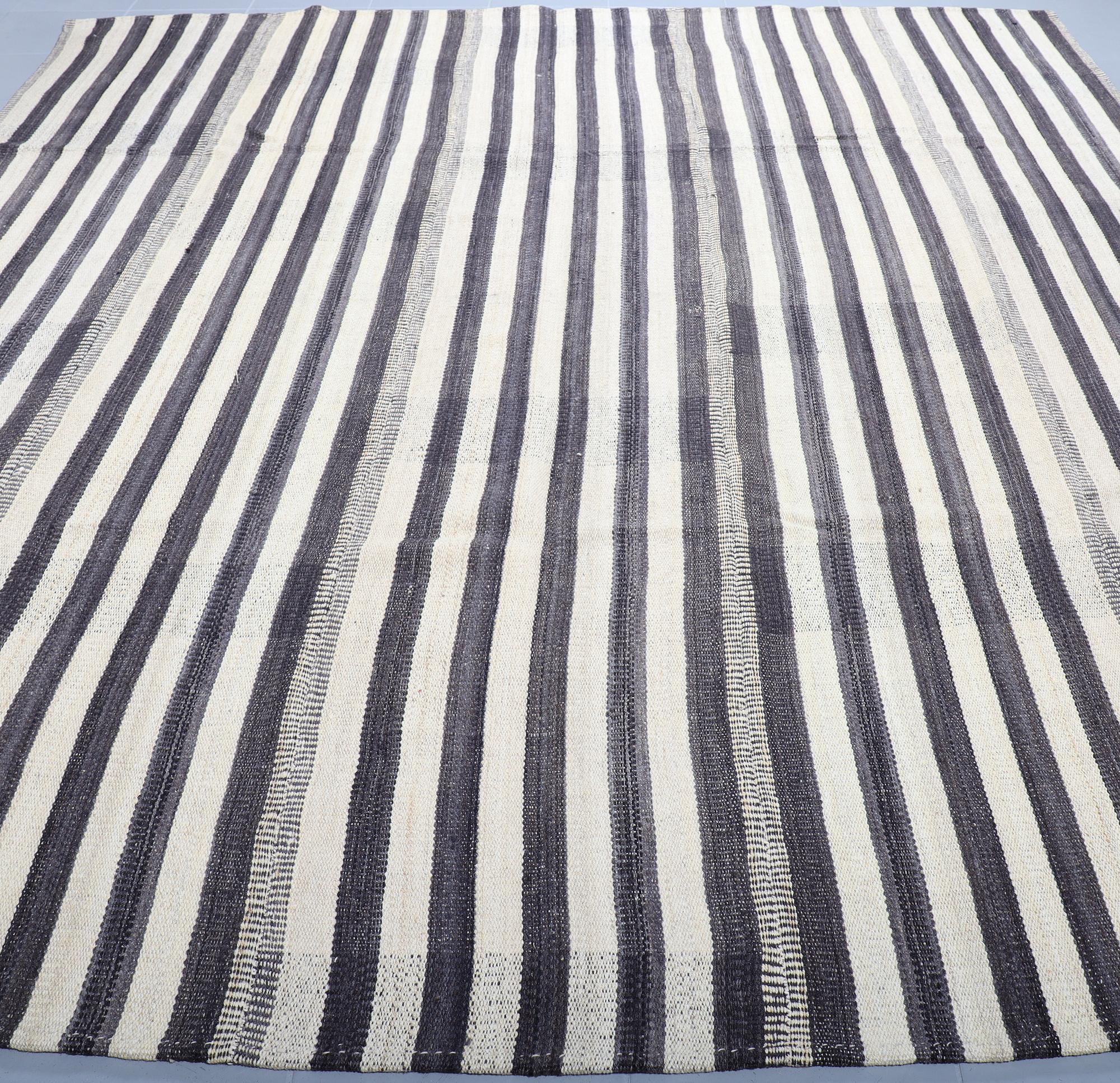 A FLATWEAVE RUG, 292 x 246 cm.