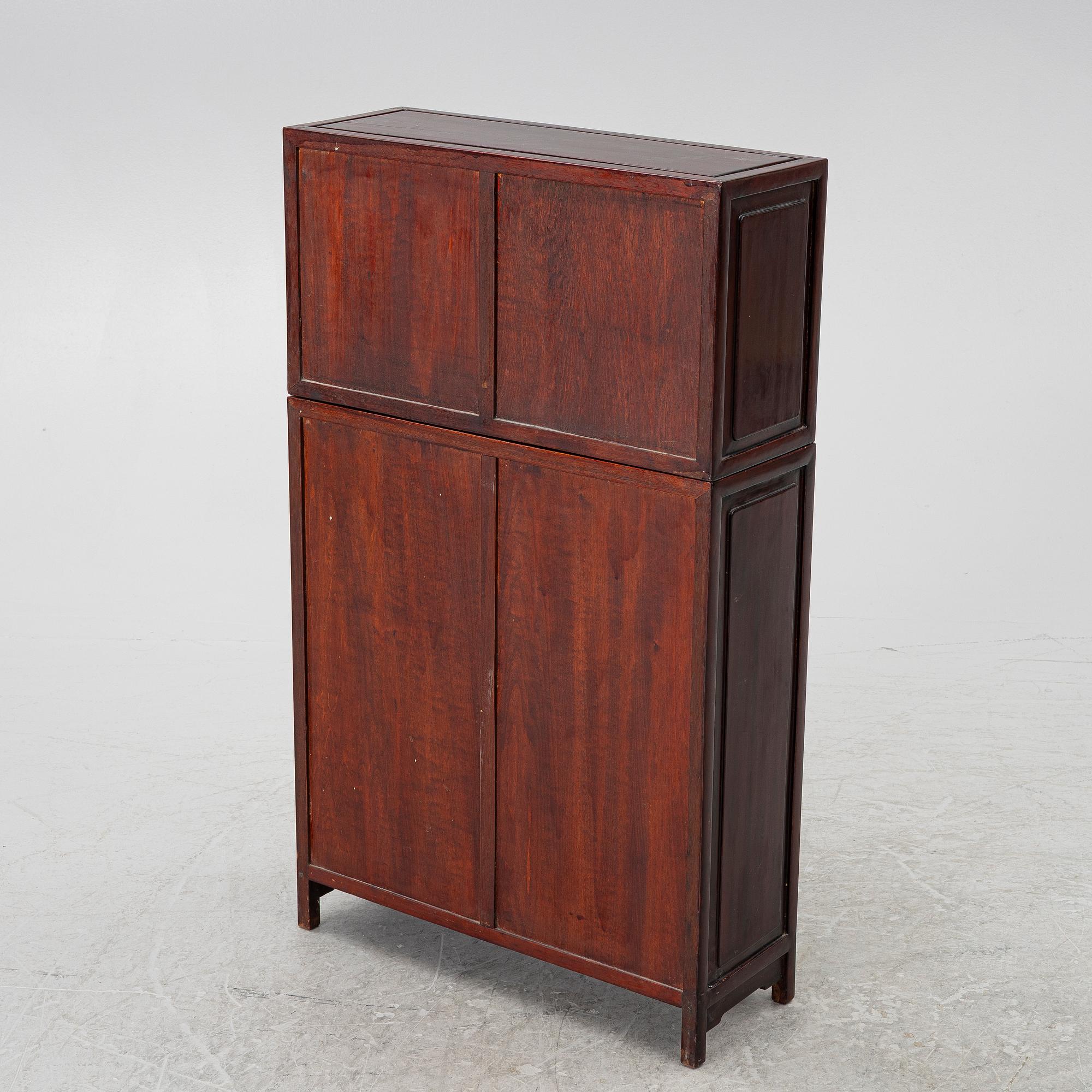A small Chinese stained wood two part cabinet, 1900s.
