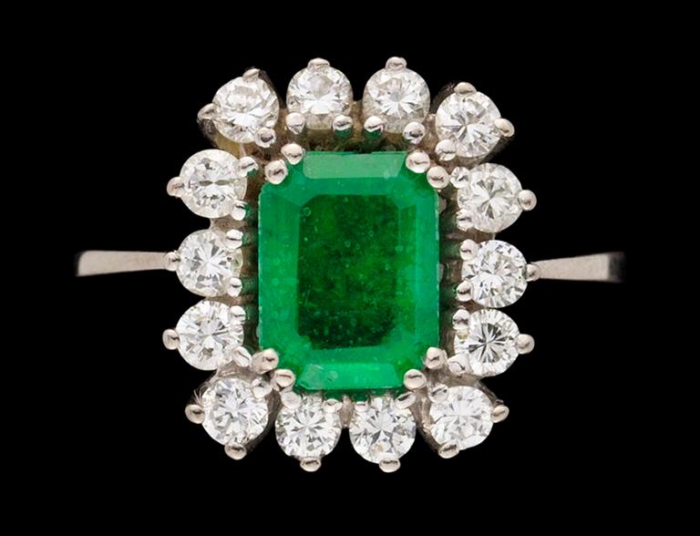 A gold, emerald and diamond ring.