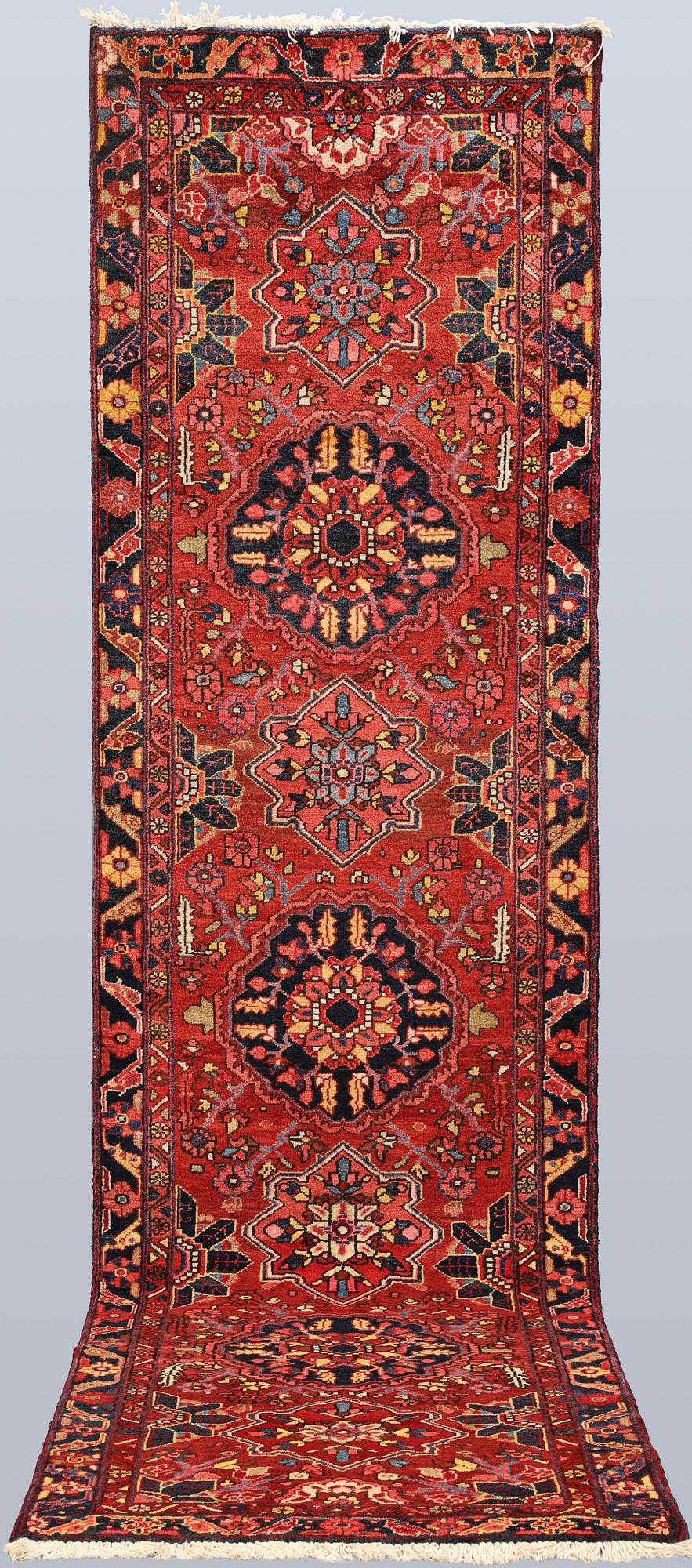 A semi-antique Heriz runner, c. 340 x 92 cm.