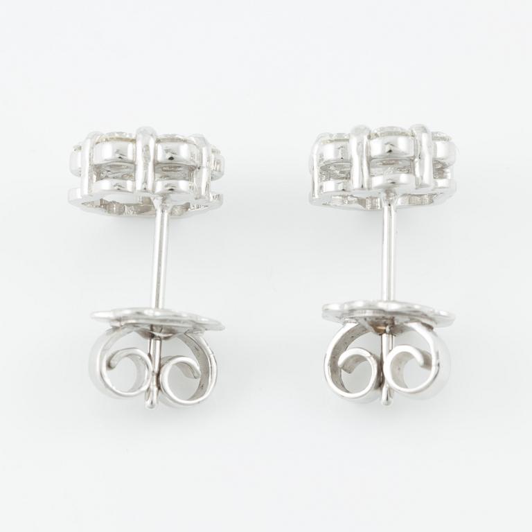 A pair of earrings in 18K white gold set with round brilliant-cut diamonds.
