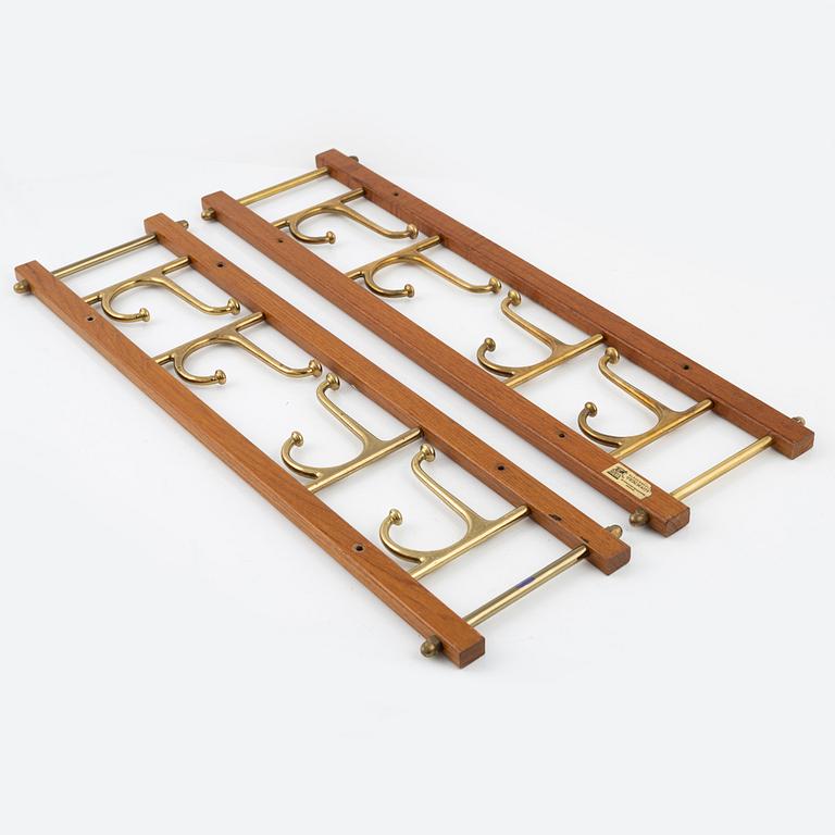 A pair of 'Dekorativ' teak coat hangers, Skoglunds metallgjuteri, Anderstorp, mid 20th Century.
