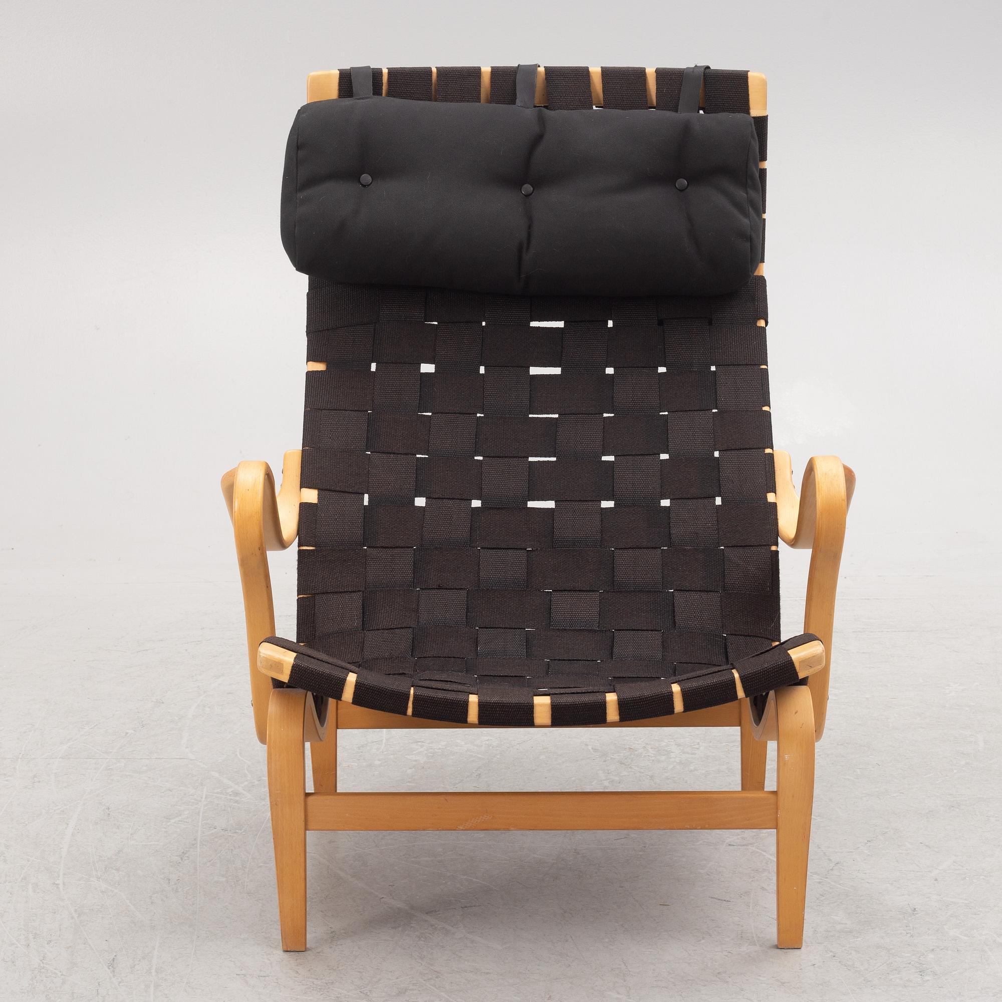 Bruno Mathsson, a "Pernilla" armchairs with ottoman, Dux, Sweden, second half of the 20th century.