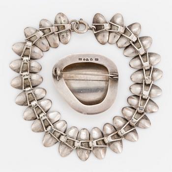 A 1950's silver bracelet and brooch.