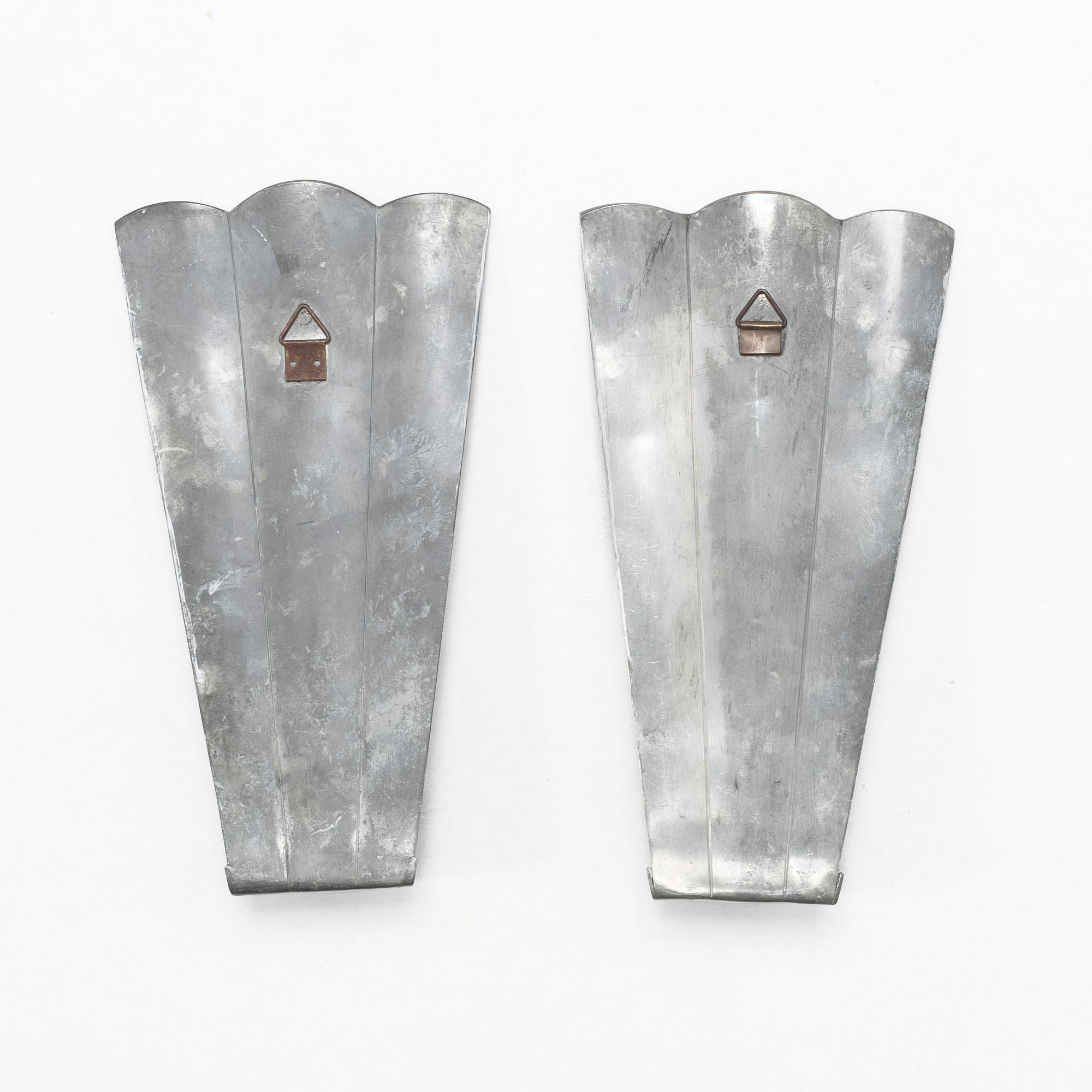 Nils Fougstedt, a matched pair of pewter and brass wall sconces, model A 60, Svenskt Tenn, Stockholm 1929 and 1932.