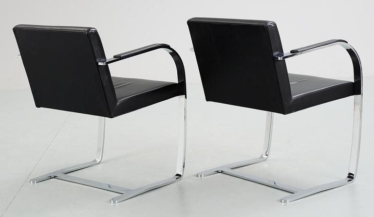 A pair of Ludwig Mies van der Rohe 'Brno' black leather and steel armchairs, Knoll International, USA.