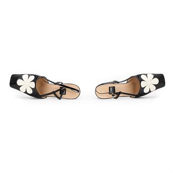 LERRE, a pair of black patent leather sandals.