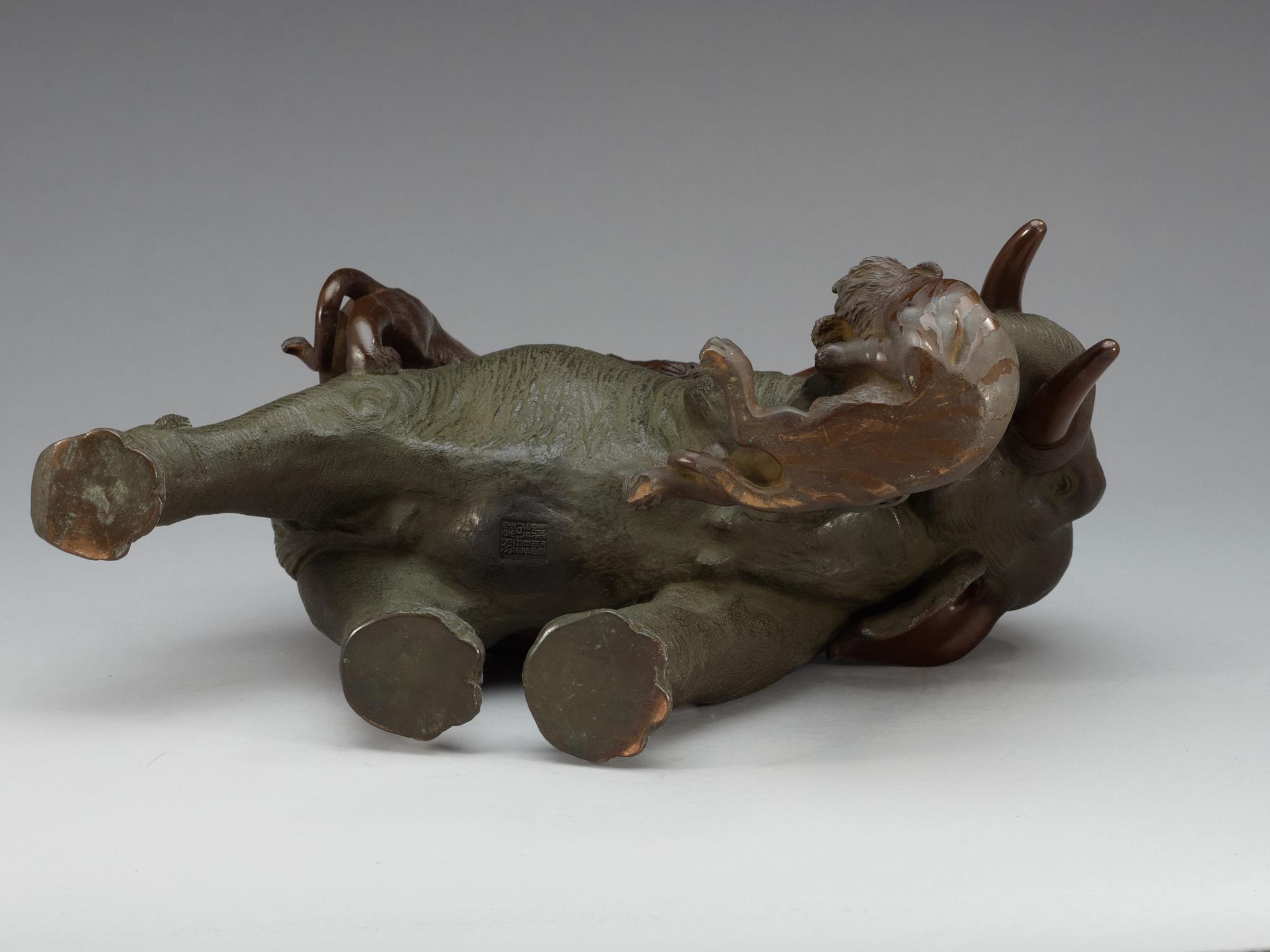 A large Japanese bronze sculpture of an elephant attacked by tigers, with seal mark, Meiji, circa 1900.