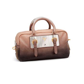 PRADA, a brown leather top handle bag.