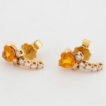 A pair of heart shaped yellow sapphire and brilliant-cut diamond earrings.