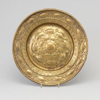 A Baroque brass repousse alms plate, Northern Europe 17th century.