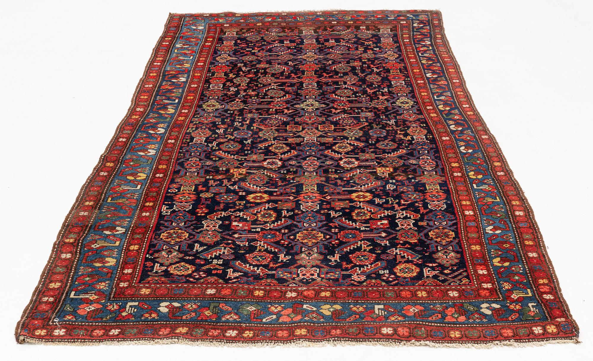 A carpet, semi-antique kurdish, circa 300 x 147 cm.