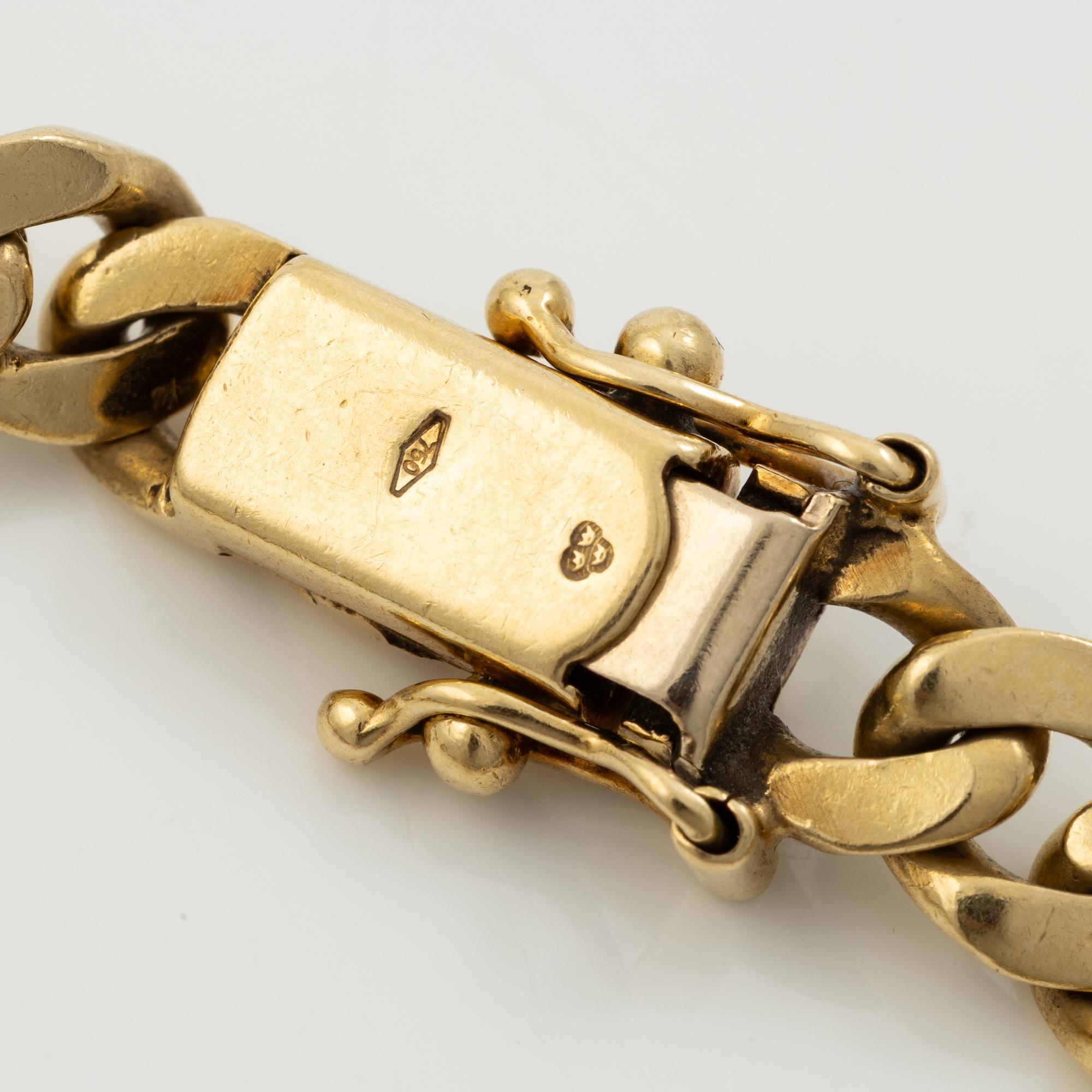 Bracelet in 18K gold set with cabochon-cut emeralds, rubies, and sapphires.