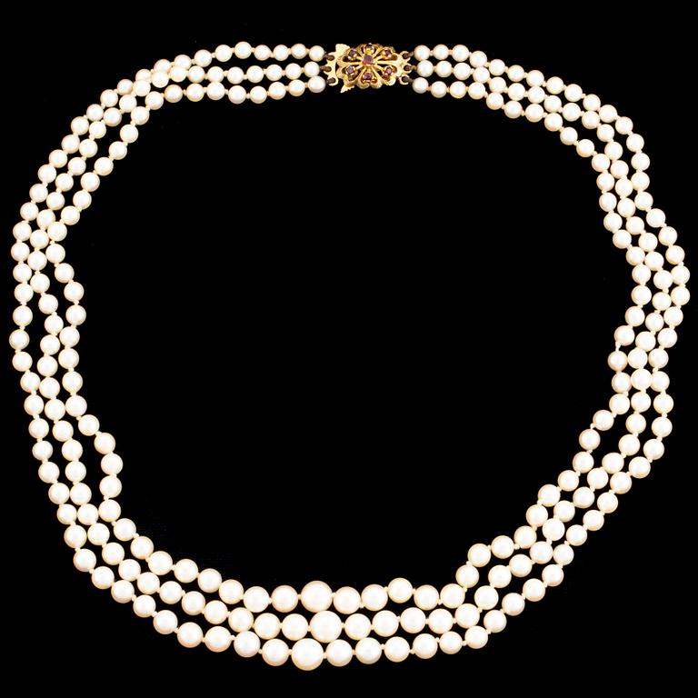 A three strand cultured pearl necklace.