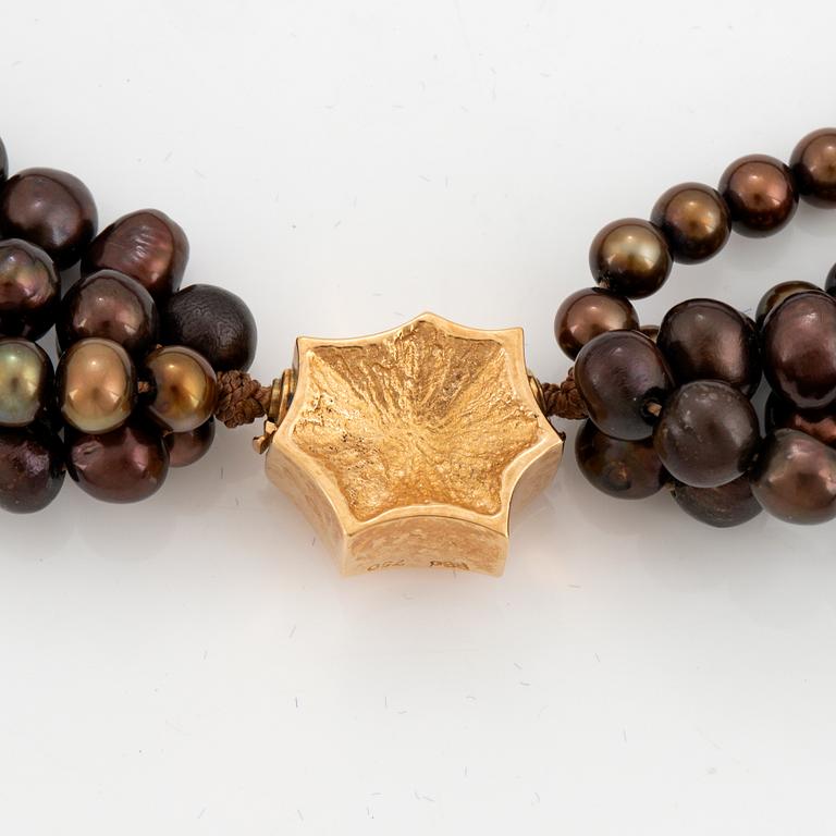 A five strand cultured pearl necklace.