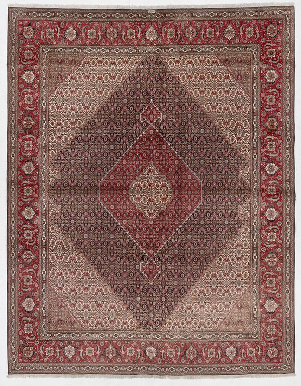 A signed Tabriz carpet, c. 385 x 300 cm.
