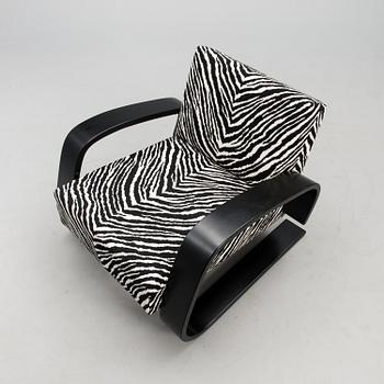 An armchair no 400, designed in 1936.