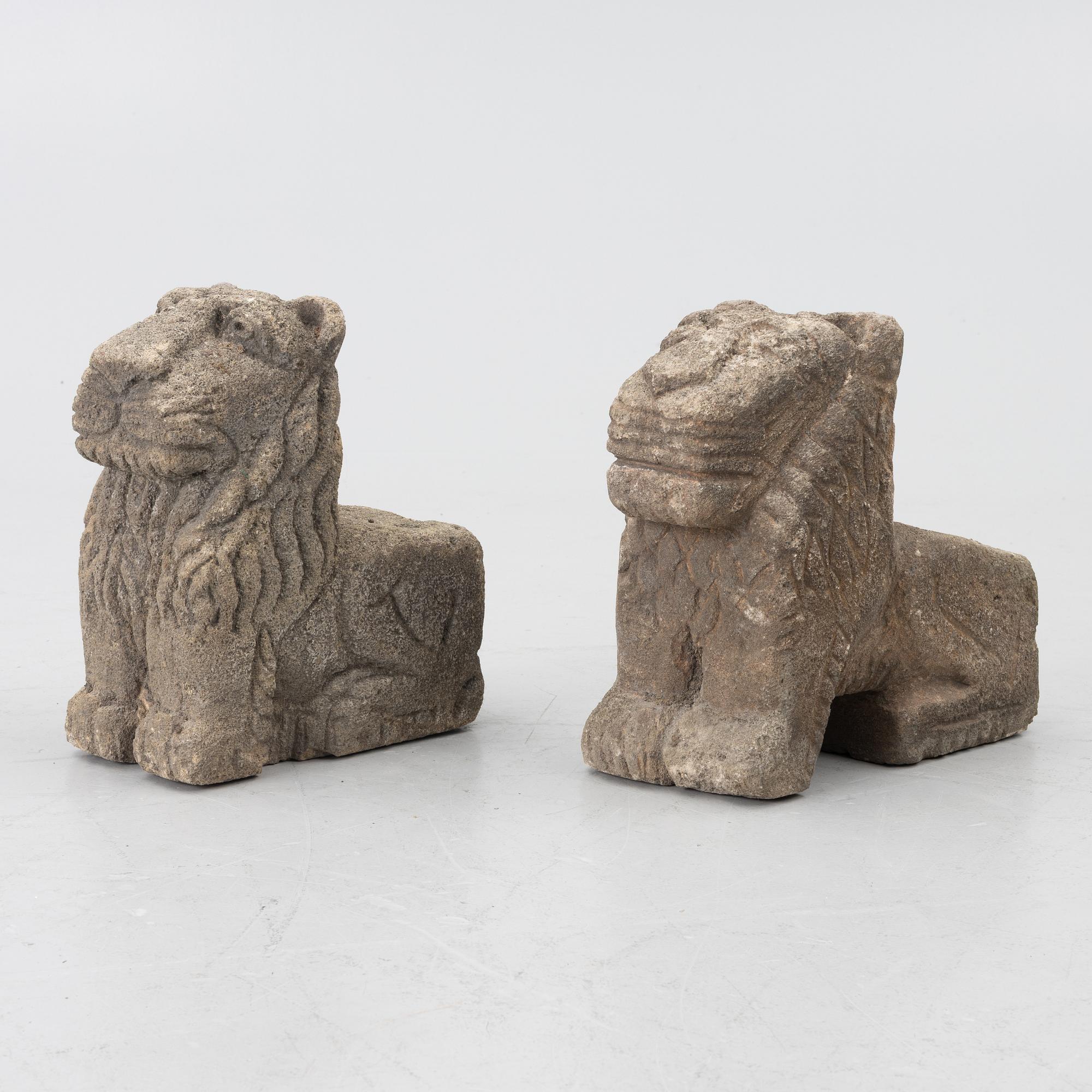 A set of two lion garden sculptures.