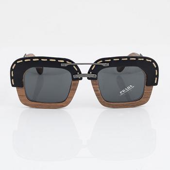 Prada, a pair of wood and leather sunglasses.