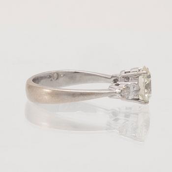 An 18K white gold ring set with one round brilliant-cut diamond and two marquise-cut diamonds.