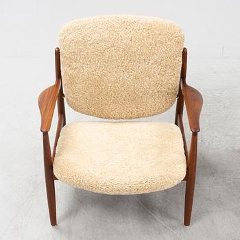 A pair of model FD 136 easy chairs with new sheepskin upholstery by Finn Juhl for France & Son, designed 1958.